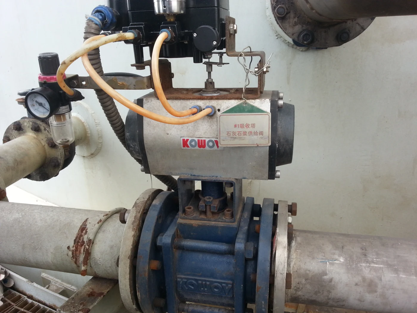 An installed KOWOV actuated valve, showing its equipment tag and connections